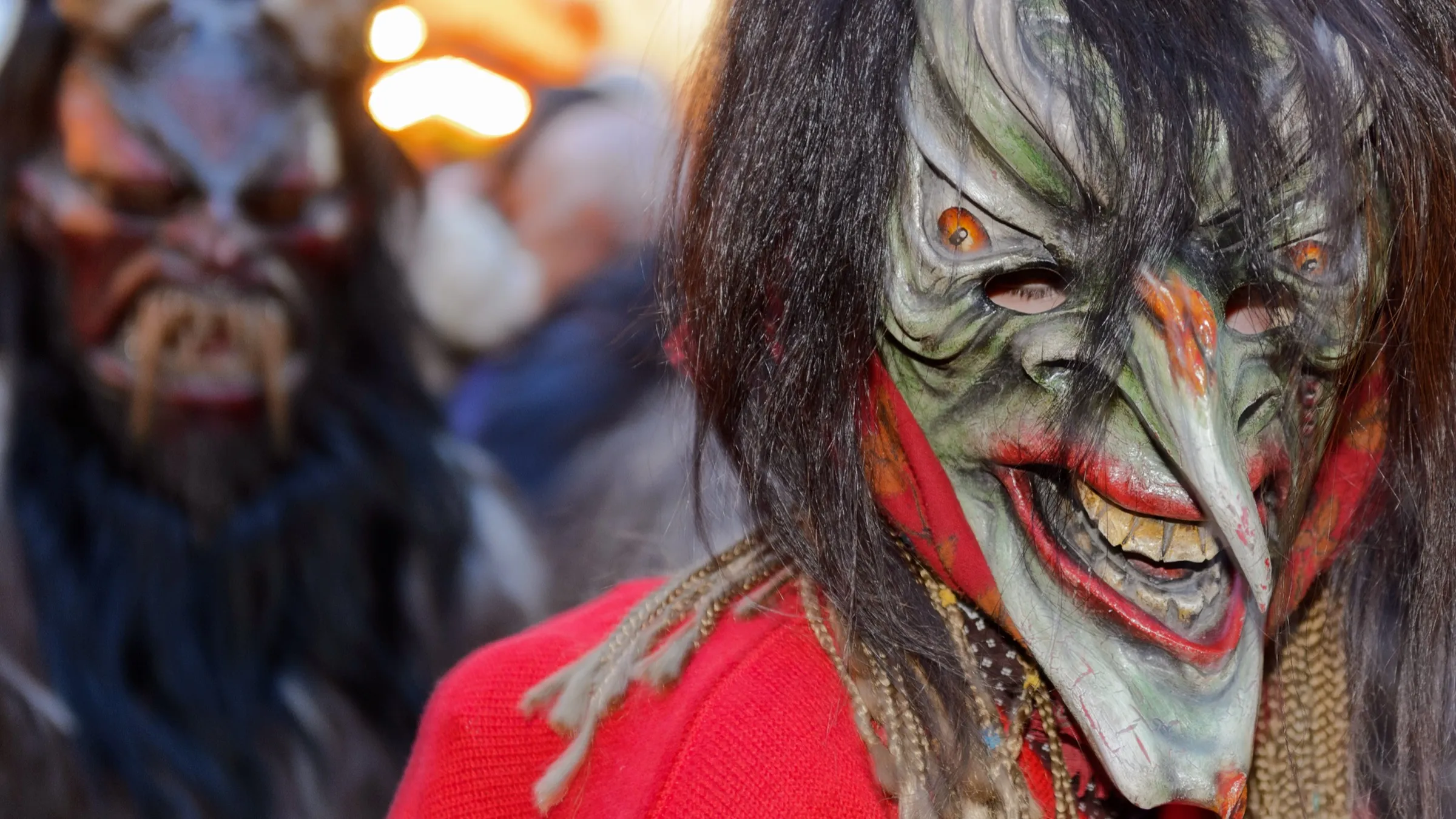 Masked Krampus and Perchten figures with hand-carved wooden masks and horns at the Krampus run on Munich's Marienplatz